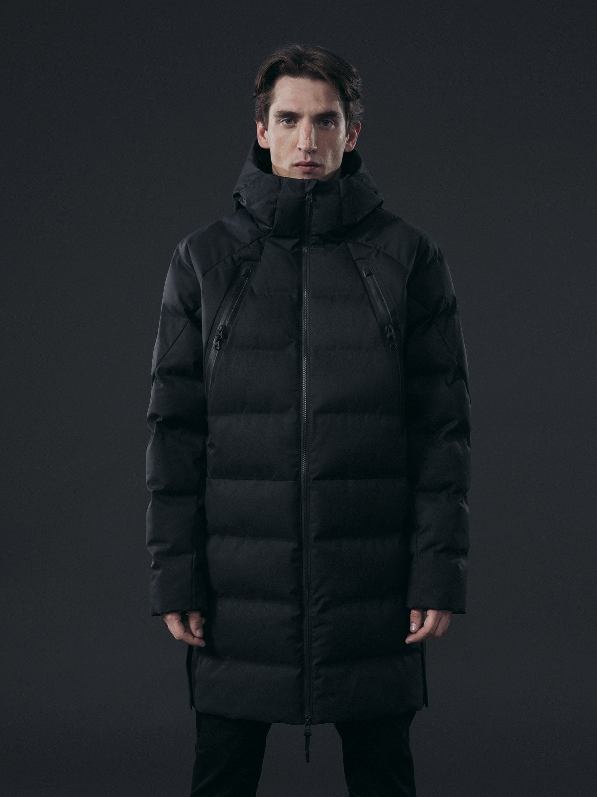 Graphic of a typography specimen showing the alphabet and numerals on top of a dark gray background.