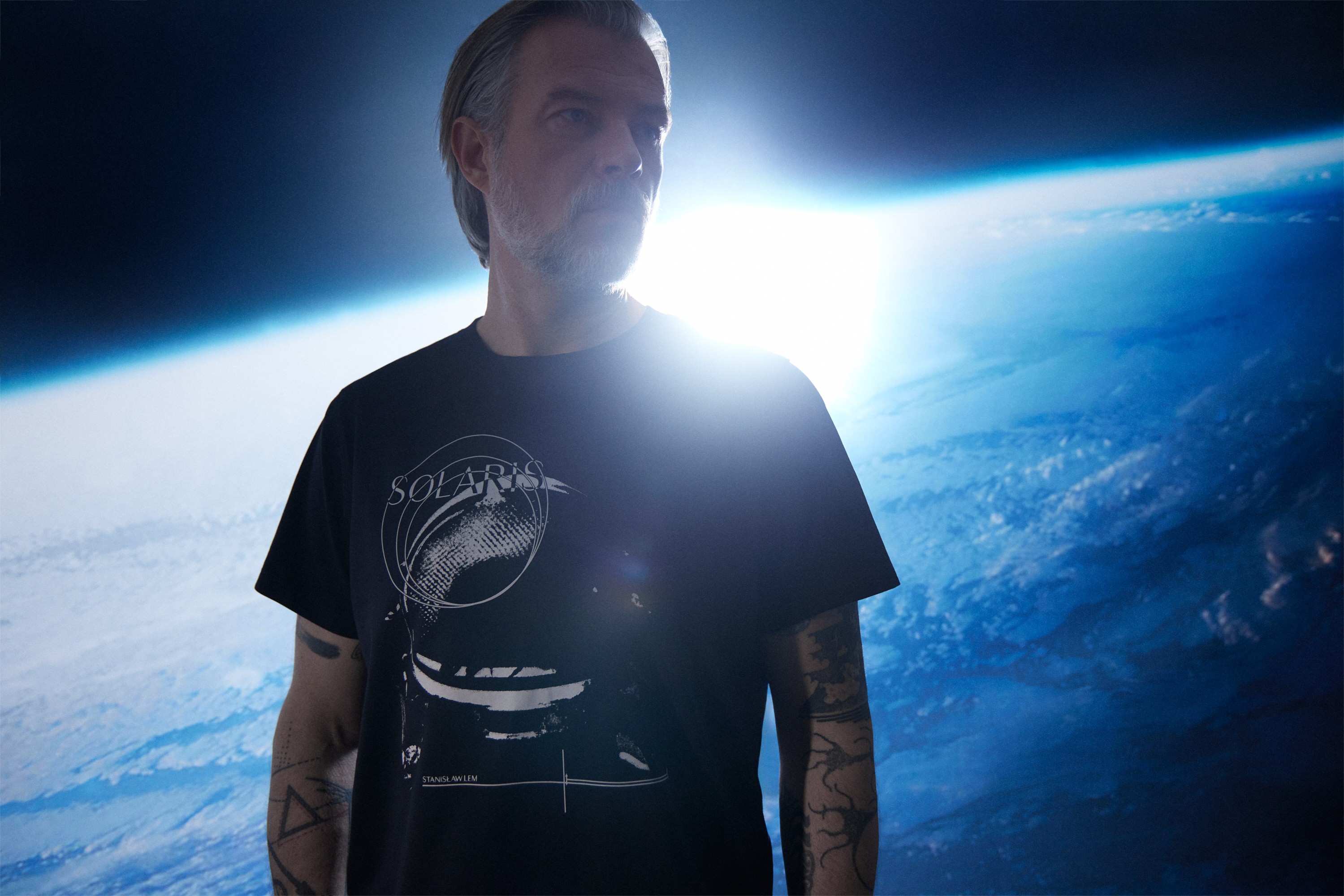 Graphic of a typography specimen showing the alphabet and numerals on top of a dark gray background.