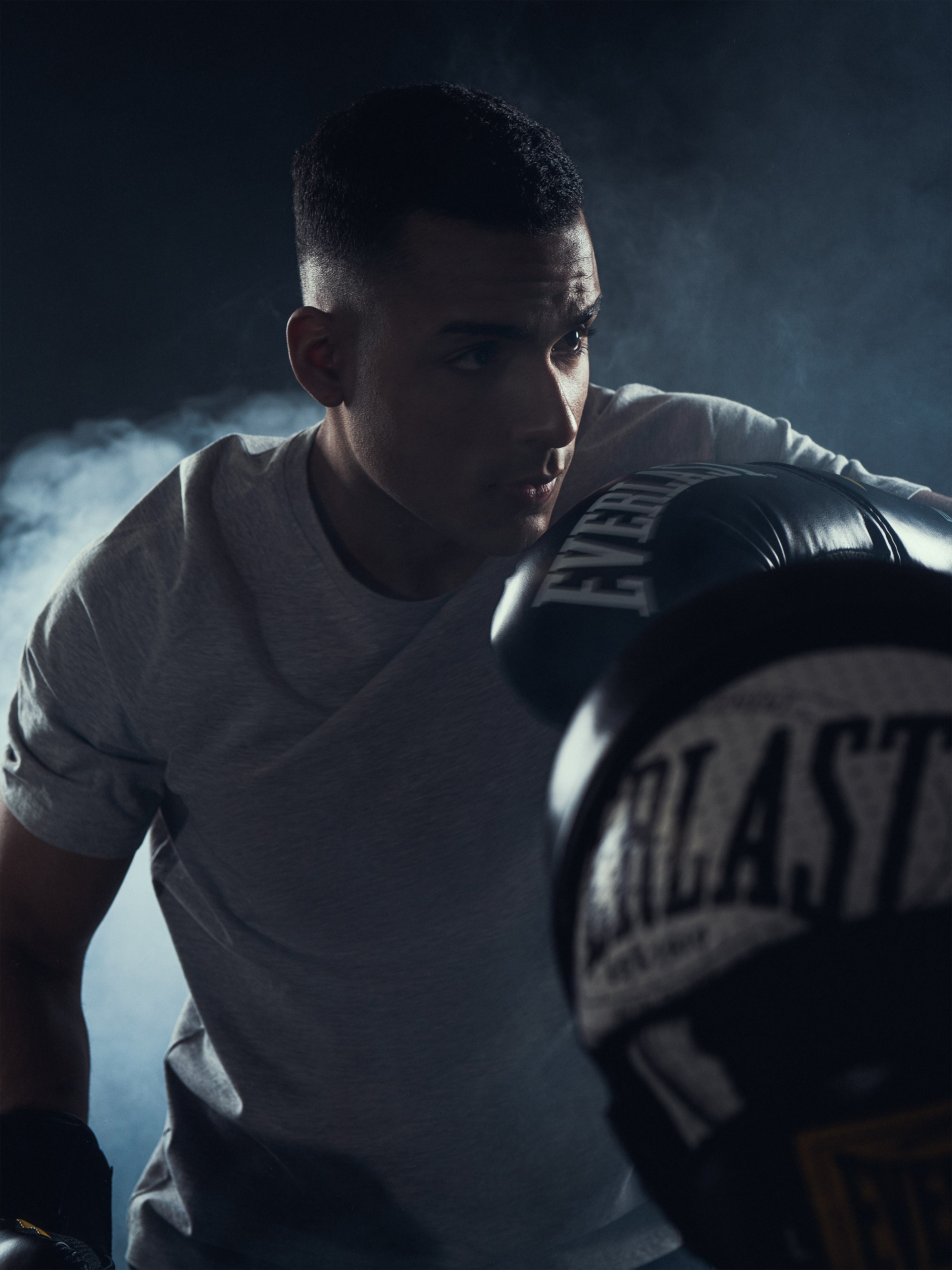 Graphic of a typography specimen showing the alphabet and numerals on top of a dark gray background.